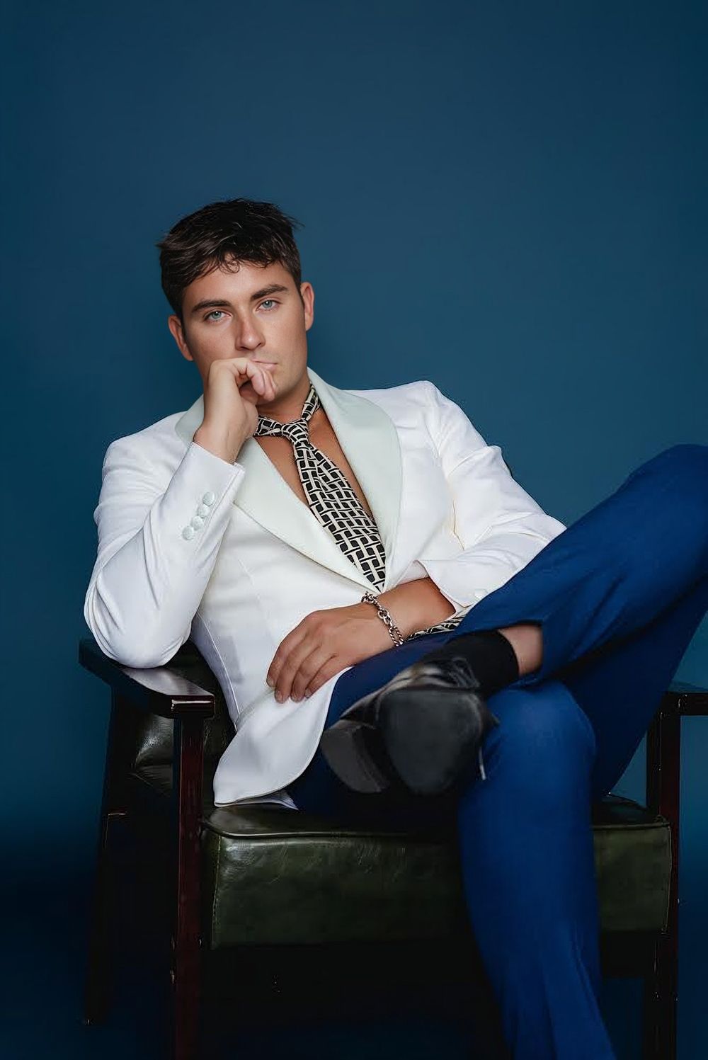 Zachary Presley seated in a white jacket, from GQ South Africa